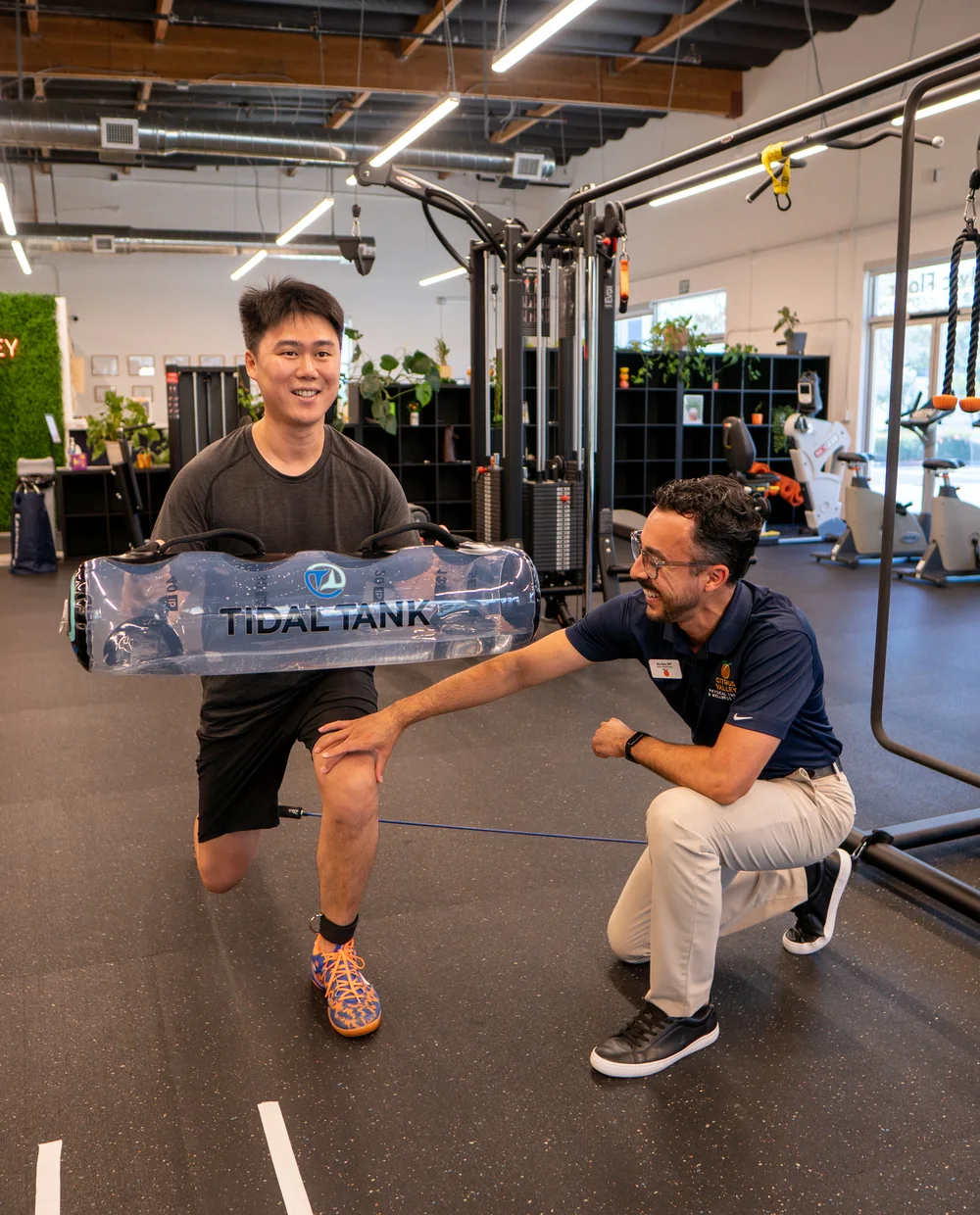 Physical therapist coaching a patient through a lunge in the Citrus Valley gym