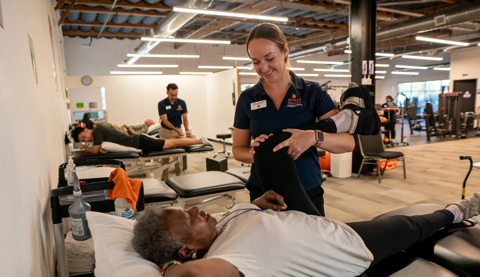 Physical therapist stretching a patient's leg on a treatment table at Citrus Valley